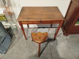 a small wooden table with a stool in front of it