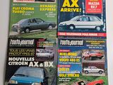 four magazines of different cars on display on a white surface