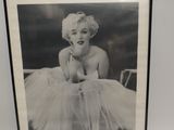 marilyn monroe in a tutu posing for a picture in a black and white photo