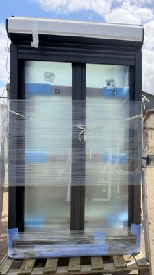 a glass door that is on a pallet in front of a house