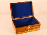 a small wooden box with a blue lining on it