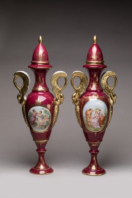 pair of red and gold vases with pictures of people on them