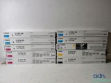 many different colors of ink cartridges on a white surface