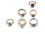 five different types of rings on a white surface