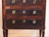 a wooden chest of drawers with brass knobs on it