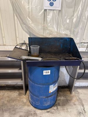 un tonneau bleu posé à côté d'une table en métal
