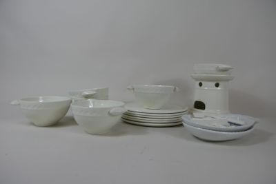 a lot of white dishes and bowls on the table