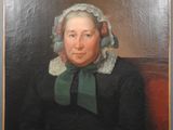 portrait of an old woman in a black dress with a green scarf
