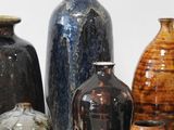 many different vases that are sitting on a table