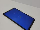 a tablet computer sitting on top of a white table