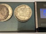 two coins sitting on top of a scale next to a clock