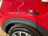 a small red car with a sticker on it ' s side