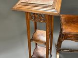 pair of antique wooden chairs and a table with a marble top