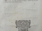an old book with a picture of a coat of arms on it
