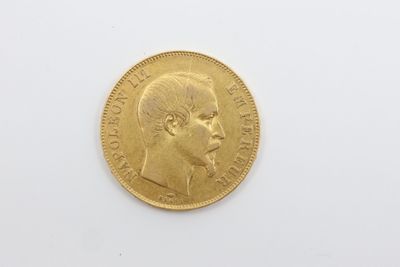 a close up of a gold coin on a white surface