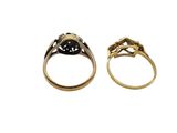 two gold rings with black stones and diamonds on them