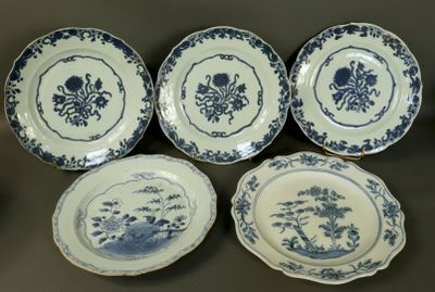 four blue and white plates with flowers and birds on them