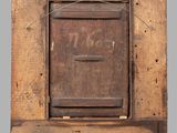 an old wooden mailbox with a number on it on a gray background