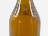 a brown glass bottle with a yellow top