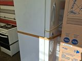 a refrigerator that is sitting in the middle of a room