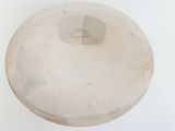 a white bowl on a white surface with a white background