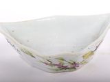 a small white bowl with a floral design on it