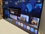 a flat screen tv sitting on top of a bed in a room