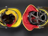 two helmets that are next to each other on a table