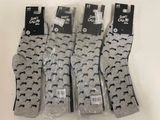 four pairs of socks with black and white designs on them