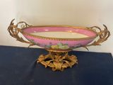 a pink and gold bowl sitting on a blue table