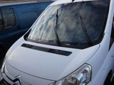a white van that is parked next to a blue van
