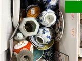 a cardboard box filled with assorted items and a pair of scissors