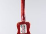 a red guitar ornament hanging from a string