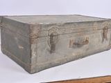 an old suitcase sitting on top of a wooden table