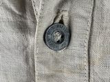 the button on the back of a jacket is visible in the picture