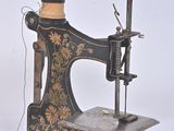 an old sewing machine sitting on a table next to a box