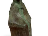 bronze statue of a woman sitting on a rock
