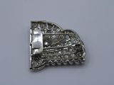 an image of a silver brooch with diamonds on a white surface
