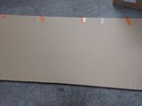 a cardboard box that is sitting on the floor next to a cardboard box