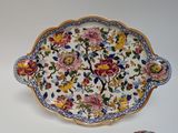 a plate with a floral design on it next to a bowl