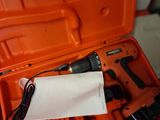 an orange tool box with a corded drill and a corded cord