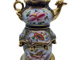 an image of a decorative teapot on a stand