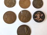 six different types of bronze coins on a white surface