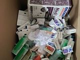 a cardboard box full of medicine and other medical supplies