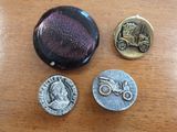 three buttons that are sitting on a wooden table