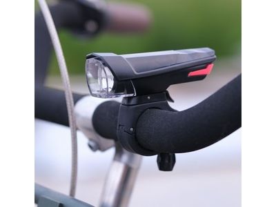 a close up of a bike handle with a light on it