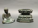two statues sitting next to each other on a table