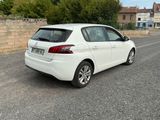 a white car that is parked on the side of the road