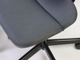 a grey office chair with a black seat on a white surface