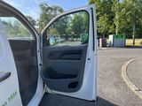 a white van with the door open in a parking lot